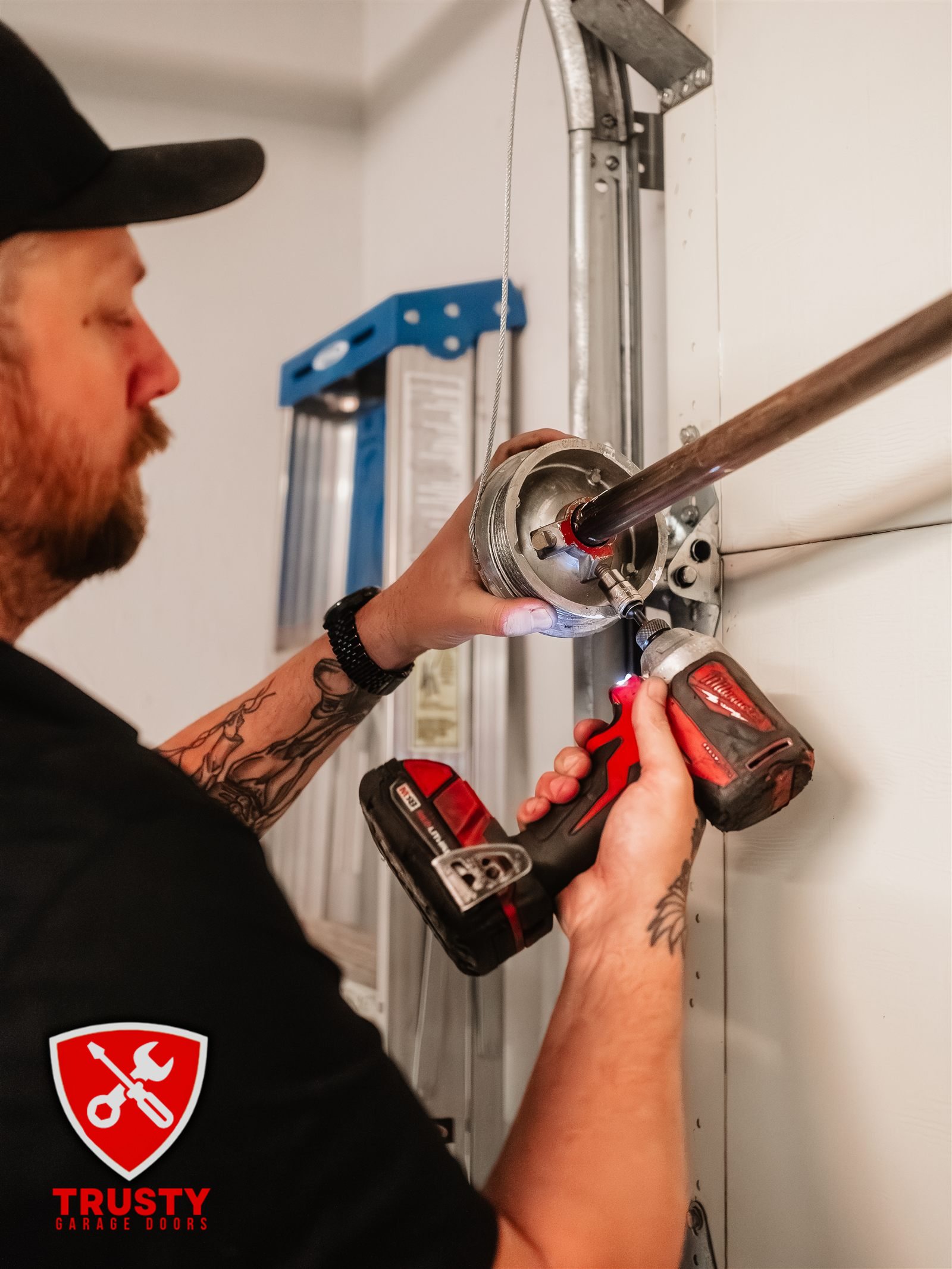 Trusty technician repairing a garage door cable drum in North Richland Hills, TX