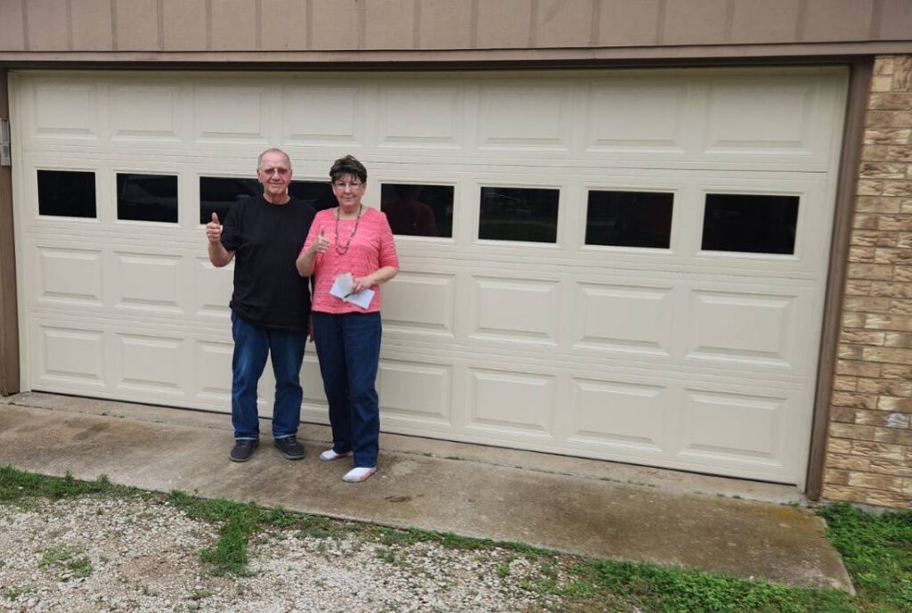 Garage Door Repair Duncanville TX, a man and woman standing in front of a garage door